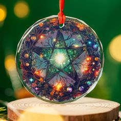 a glass ornament with an image of a star in the center on top of a piece of wood