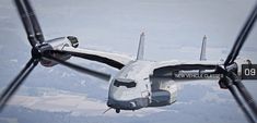 an airplane flying through the air with propellers