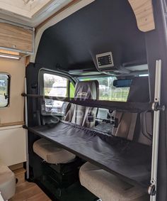 the interior of a camper van with its bed pulled up to it's side