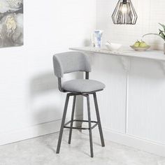 a bar stool in front of a counter with a potted plant on the side