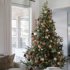 a living room with a christmas tree in the corner