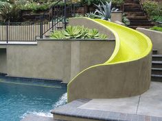 an outdoor swimming pool with steps leading up to it and plants growing on the wall