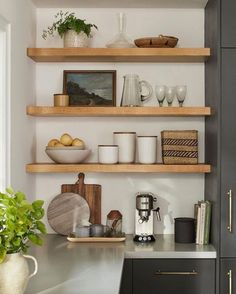 a kitchen with open shelving and wooden shelves