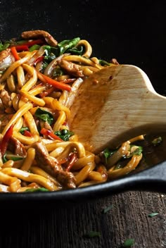 stir fried noodles with meat and vegetables in a skillet