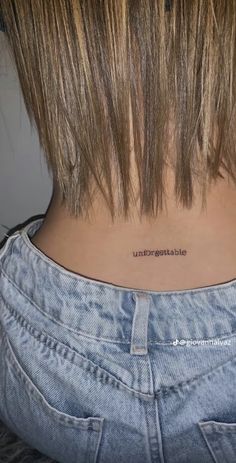 the back of a woman's neck with an inscription on it