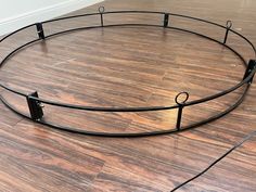 an empty round metal bed frame on the floor