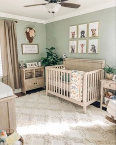 a baby's room with a crib, dressers and pictures on the wall