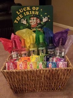 a basket filled with lots of different types of candy in front of a sign that reads luck of the irish