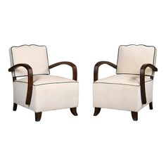 a pair of white chairs sitting next to each other