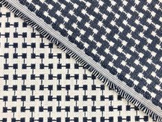 some black and white checkered fabric with different patterns on it's edges, close up