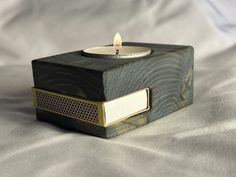 a wooden box with a lit candle in it