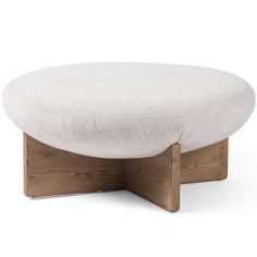 a white ottoman sitting on top of a wooden frame