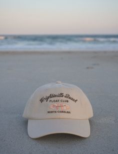 Inspired by North Carolina's east coast summers. Floating in the intercostal with sandy toes & sun-kissed skin. A beige cap with, dark brown embroidery, and a luxe satin interior lining. Adjustable Flat Brim Trucker Hat For Beach, Beach Floats, Beige Cap, Brown Embroidery, Winter Headwear, Wrightsville Beach, Dad Cap, Dad Caps, Cayman Islands