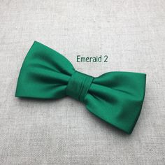 "We proudly present our premium handmade pre-tied bow tie for Adult/Men/Women/Kids/Children/Toddler/Baby boy/girl.... **The bow tie is pre tied and hand stitched into place.** Material: Satin Choose your Bow tie ATTACHMENT/STRAP: - CLIP-ON (strapless) - Adjustable VELCRO strap - Adjustable strap with METAL HOOK, EYE ADJUSTER HARDWARE SIZES are shown below: - NEWBORN-1YR : Adjustable straps fit 7\" up to 11\" neck circumference. - TODDLER (1-3YR) : Adjustable straps fit 10\"-12\" neck circumferen Classic Green Bow Tie For Formal Occasions, Classic Green Tie With Satin Bow, Classic Green Suit And Tie Accessories With Satin Bow, Classic Green Bow Tie For Gifts, Classic Green Bow Tie And Suit Accessories, Classic Adjustable Green Bow Tie, Classic Green Bow, Classic Green Bow With Bow Tie Back, Classic Green Bow Tie For Party