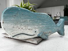 a wooden whale planter sitting on top of a table