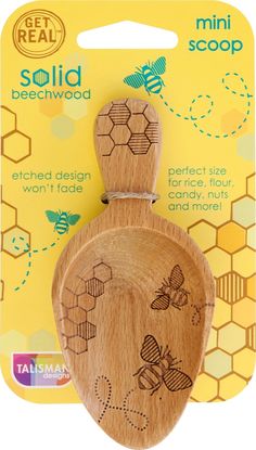 a wooden spoon with bees on it in front of a package for the beehive