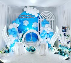 balloons and decorations are set up on the stage for an event with blue and white decor