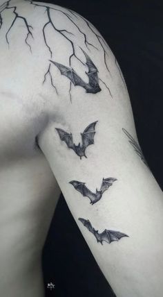 the back of a man's arm with bats on it and lightning behind him