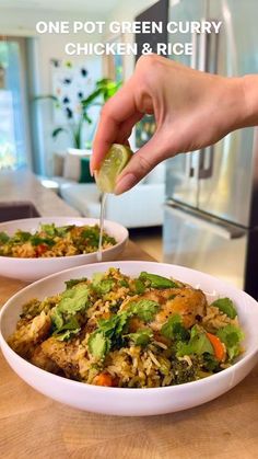 a person is dipping something into a bowl with rice and broccoli in it