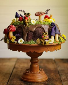 a chocolate cake with mushrooms and flowers on top