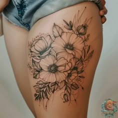 a woman's thigh with flowers on it