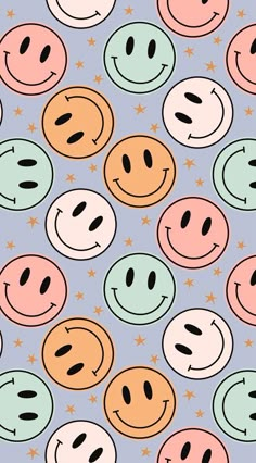 many different colored smiley faces on a blue background