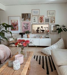 a living room filled with lots of furniture and pictures on the wall above it's coffee table