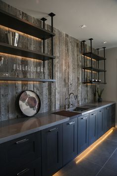 a modern kitchen with stainless steel appliances and shelving