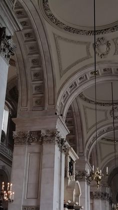 the interior of a large building with chandeliers