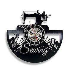 a black clock with sewing tools on it