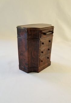 an old wooden chest with drawers on the top and bottom, against a white background