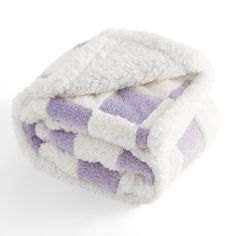 a purple and white checkered towel folded on top of each other