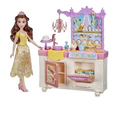 a doll is standing in front of a toy kitchen with princess's accessories on it