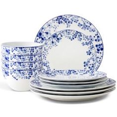 the blue and white dishes are stacked on top of each other