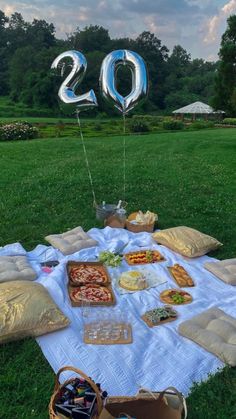 a picnic with food and balloons in the shape of numbers