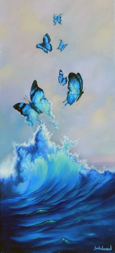 three blue butterflies flying over the ocean waves