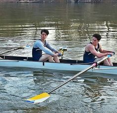 two men in a canoe paddling on the water