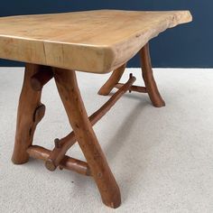 a wooden table with two legs on top