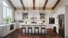 a large kitchen with wooden floors and white cabinets is pictured in this image, there are four stools at the center of the island