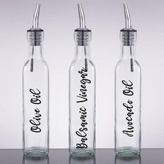 three empty glass bottles with the words, one for each