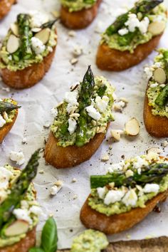 many pieces of bread with different toppings on them and some type of appetizer