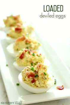 deviled eggs are lined up on a white plate with the words loaded deviled eggs