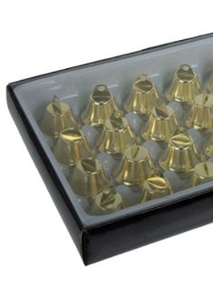 an assortment of brass bells in a black box