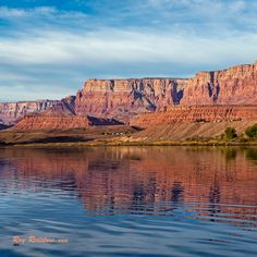 the mountains are reflected in the still water