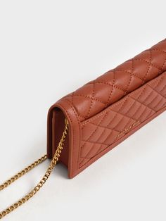 For those who wish to protect and organise their favourite tech accessories while showcasing impeccable style, simply turn to our Micaela long wallet. Fashioned with a tactile quilted body, in a captivating brick-red shade, and crowned with a gilded metallic accent, it embodies a fearlessly chic aesthetic. Compact yet spacious enough, this gem is the perfect size for your phone and other small gadgets. Carry it on its own or slip it into your everyday bags for optimum organisation. Small Gadgets, Belt Ring, Chic Aesthetic, Size Chart For Kids, Charles Keith, Phone Pouch, Kids Sale, Sand Color, Everyday Bag