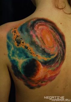 the back of a woman's shoulder with a colorful tattoo design on her upper half