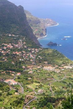 an aerial view of a small village on the edge of a cliff overlooking the ocean