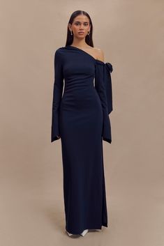 Contemporary glamour. The NICOLA One Shoulder Crepe Maxi Dress is a stunning blend of modern elegance and timeless sophistication. Featuring an asymmetrical neckline with a chic open shoulder and ruched detailing, this dress exudes contemporary glamour. The ruching at the waist enhances the silhouette, creating a flattering, body-skimming effect. With a functional tie at the shoulder for adjustable styling, a side zip for a smooth fit, and stretch fabrication for added comfort, the Nicola Dress Capsule Wardrobe Accessories, Matric Dress, Capsule Wardrobe Basics, Crepe Maxi Dress, European Summer Outfits, Wardrobe Accessories, Maxi Dress Sale, Capsule Outfits, Asymmetrical Neckline