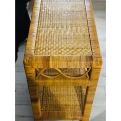 a table made out of wood and wicker with one drawer on the bottom shelf