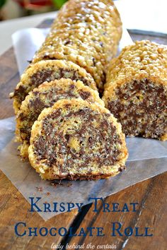 some kind of chocolate roll sitting on top of a wooden table with the words krispy treat chocolate roll